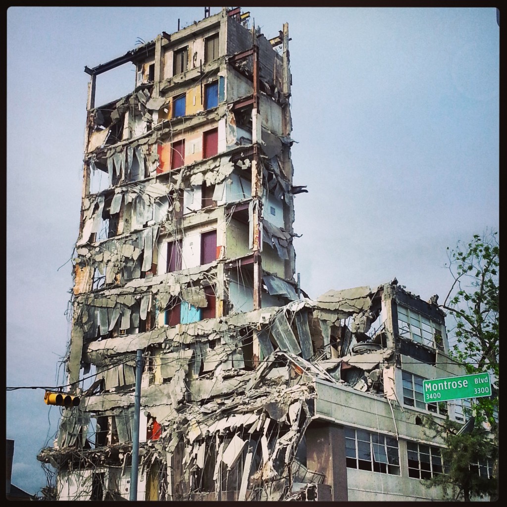 Photo of demolished building with colored elevator doors revealed