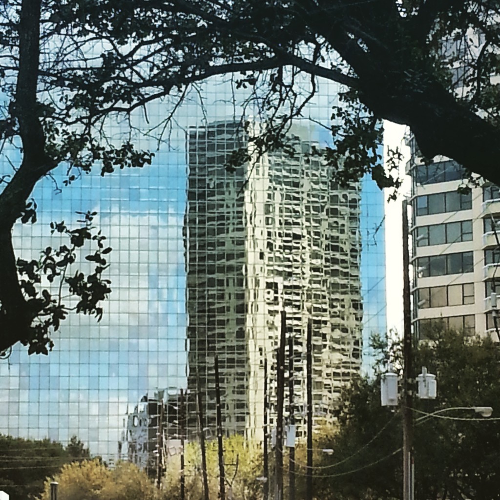 Photo of a Houston building reflected in the glass of another buidling